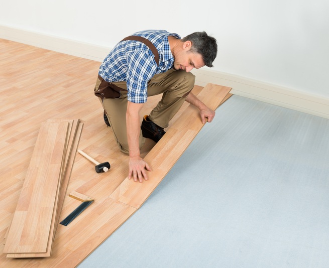 Man installing laminate